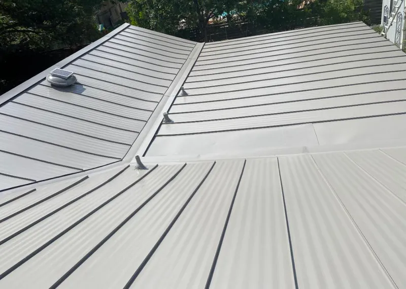 Solar attic fan installed on a metal roof for Roof Ventilation in Kentwood